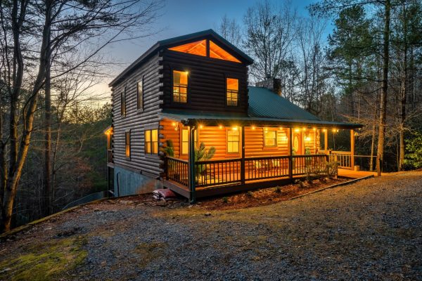 Lit up at night, the cabin oozes charm and tranquility. You can sit out on multiple decks and enjoy the fresh air. The large circular driveway has all the parking you will need.
