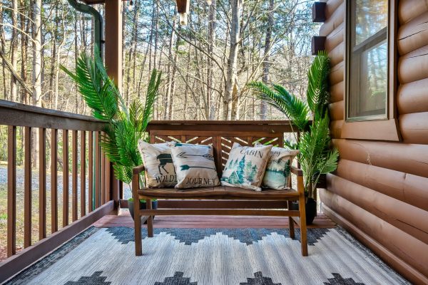 Nature's perfect seat - take a moment to enjoy the peaceful serenity of the outdoors on our cozy deck bench