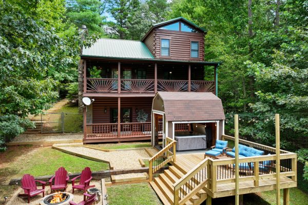 Your mountain oasis awaits: open fire pit, covered hot tub and amazing outdoor decks to relax on. Embrace mountain cabin living