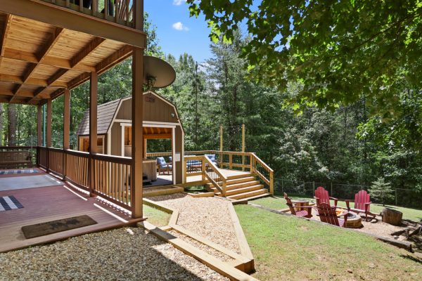 A path from the cabin to the hot tub, outdoor deck and firepit